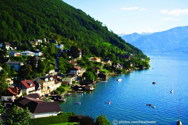 Boats moored in Gmunden on Traunsee Lake, view of hills and mountains in background