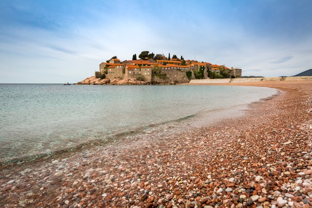 A sweeping stretch of one of Sveti Stefan’s pebbled beaches